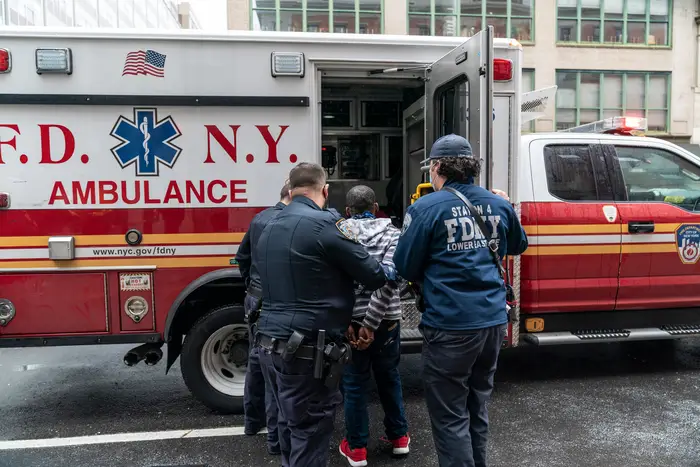 NYPD and FDNY detain a man and place him in an ambulance following a public disturbance on Murray Street in Manhattan, Oct. 13, 2020.
